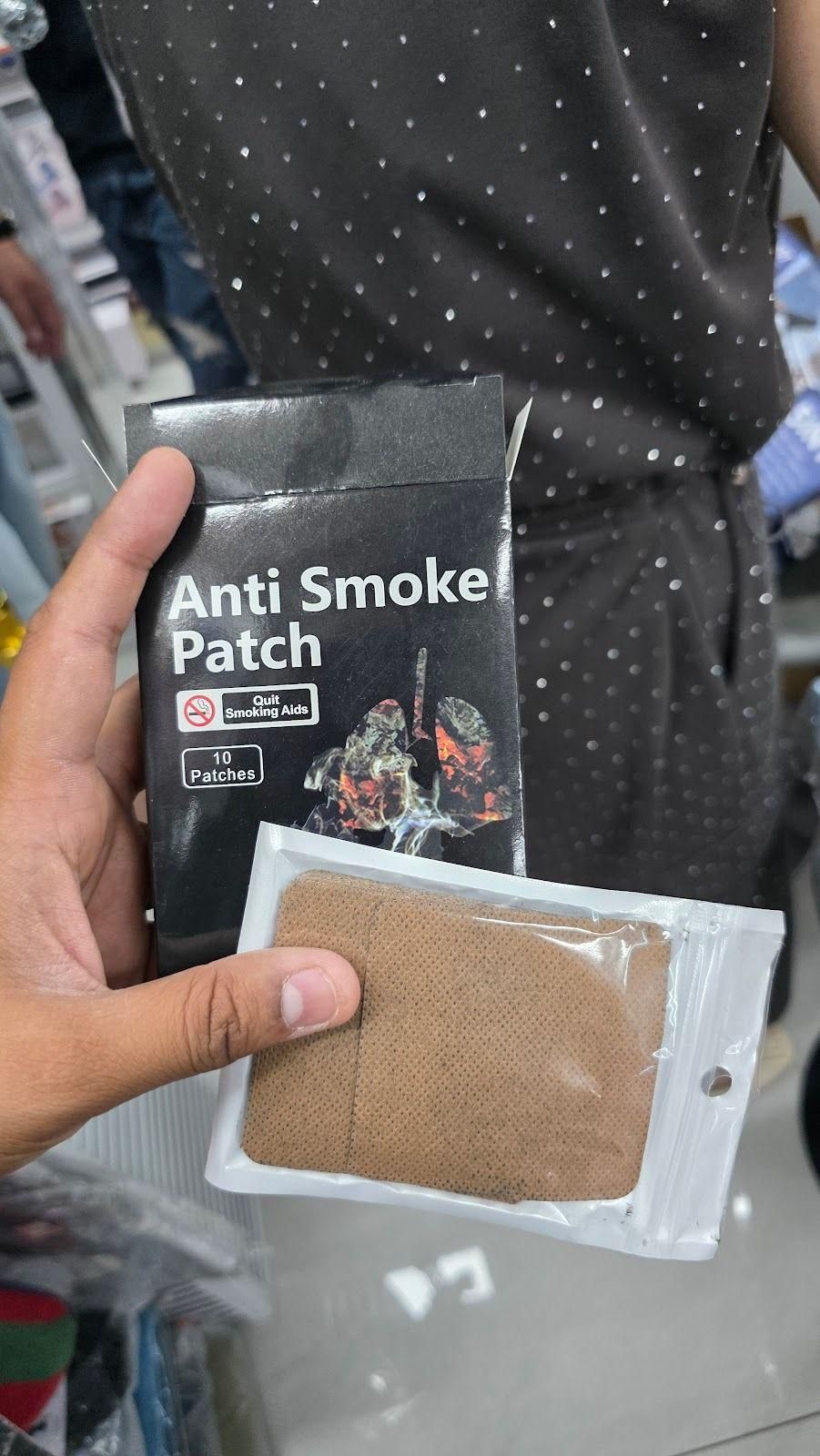 Person holding Anti Smoke Patches (Pack of 10) with visible packaging and patch.